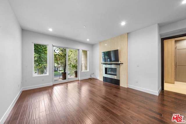 unfurnished living room with dark hardwood / wood-style flooring