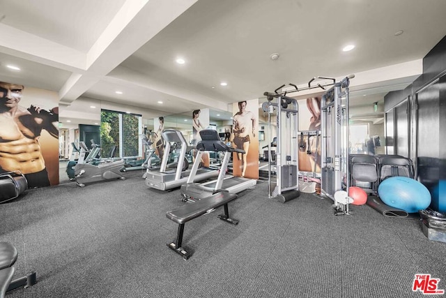 workout area with coffered ceiling