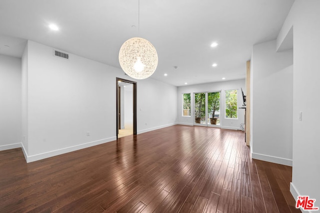 unfurnished living room with dark hardwood / wood-style flooring