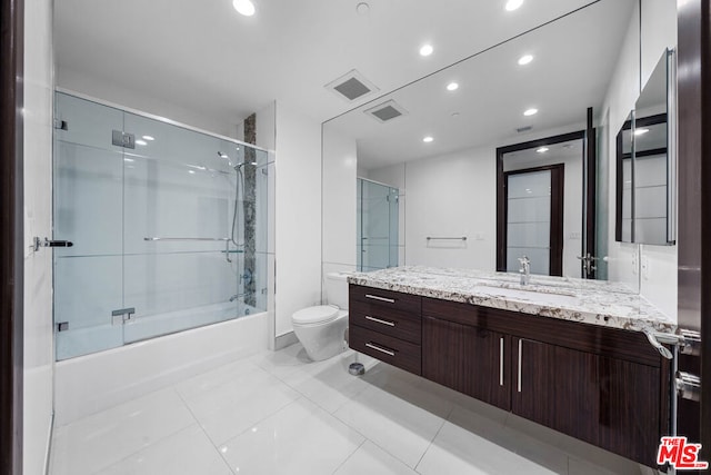 full bathroom with tile patterned flooring, vanity, toilet, and enclosed tub / shower combo