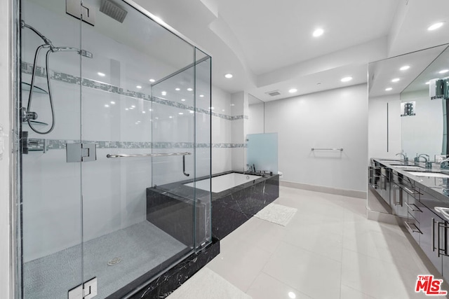 bathroom with tile patterned flooring, vanity, and independent shower and bath