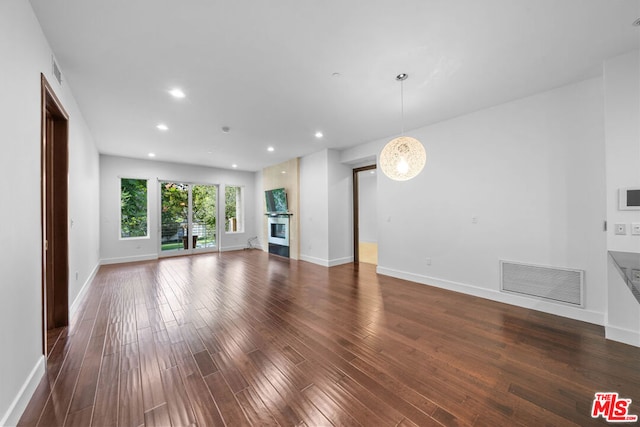 unfurnished living room featuring dark hardwood / wood-style floors