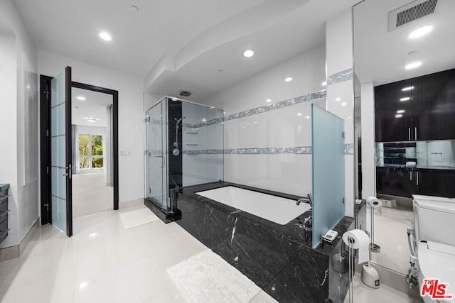 bathroom featuring tile patterned flooring, vanity, and separate shower and tub