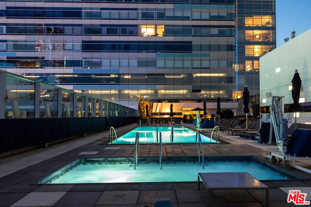 view of swimming pool with a patio area and a community hot tub