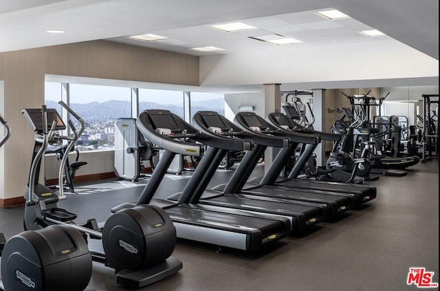 exercise room with a mountain view