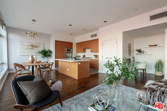 kitchen featuring stainless steel appliances, a center island, and dark wood-type flooring