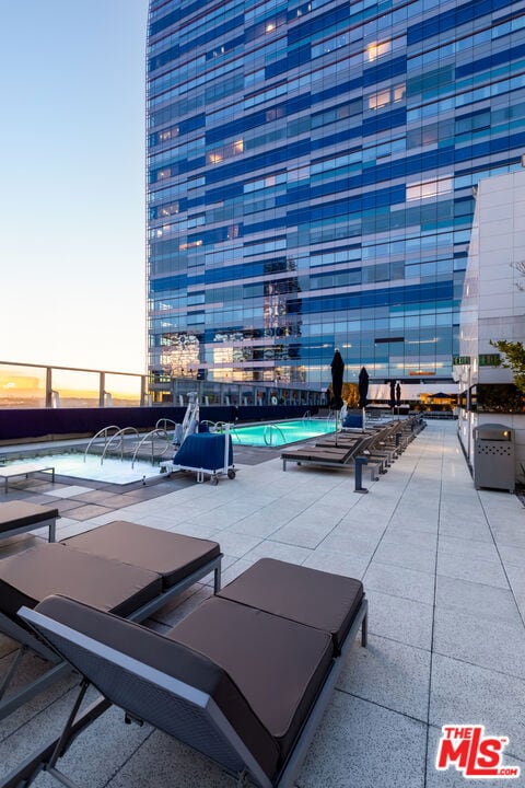 patio terrace at dusk with a community pool