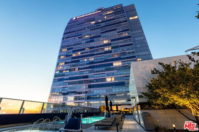 view of building exterior featuring pool water feature