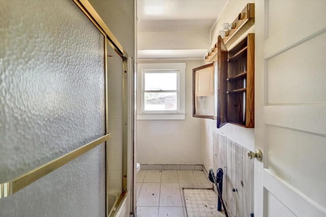 washroom with light tile patterned flooring