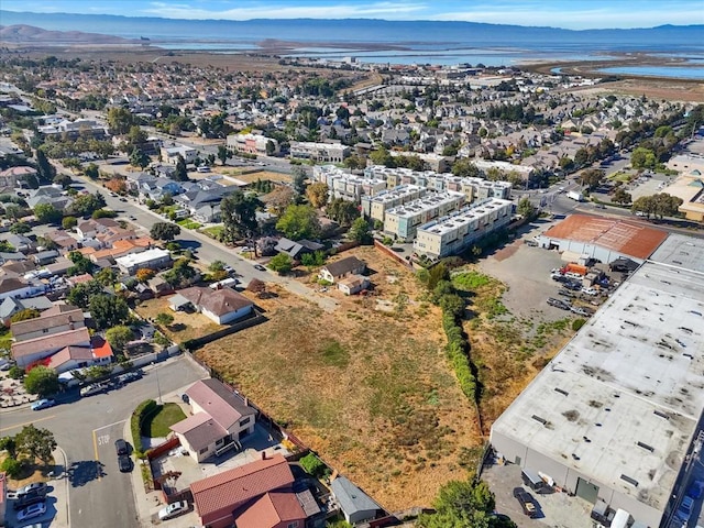 birds eye view of property with a water and mountain view