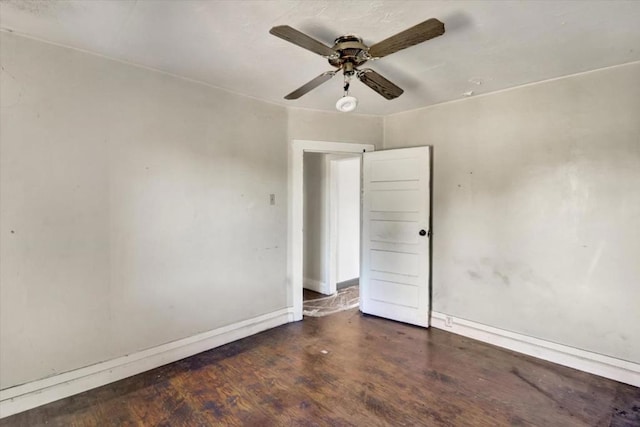 empty room with ceiling fan and dark hardwood / wood-style floors