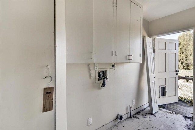 laundry area with cabinets