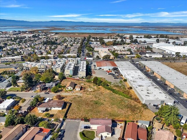 birds eye view of property featuring a water and mountain view