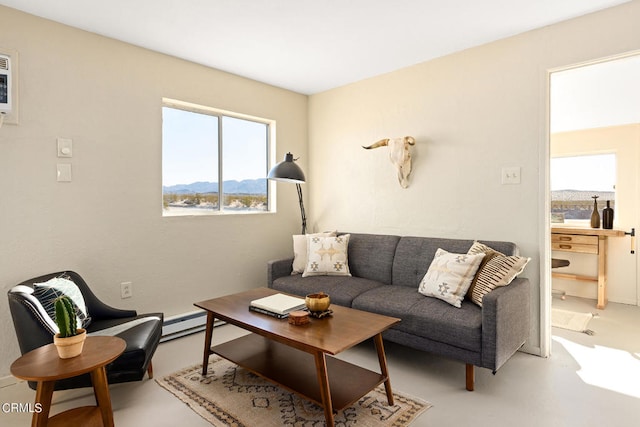 living room featuring concrete floors, a mountain view, and baseboard heating