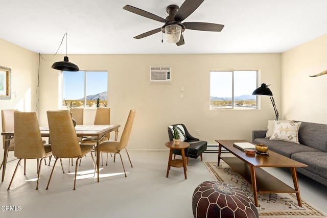 dining space with a healthy amount of sunlight, ceiling fan, a wall mounted AC, and a mountain view