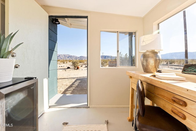 doorway with a mountain view, wine cooler, and lofted ceiling