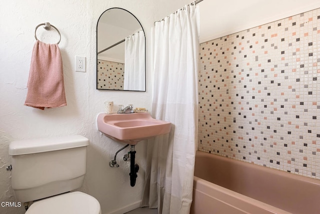 full bathroom with sink, shower / tub combo, and toilet