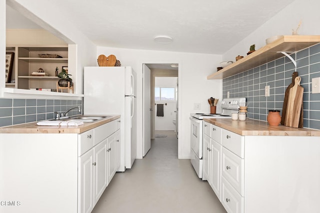 kitchen with wood counters, sink, white cabinetry, decorative backsplash, and white appliances