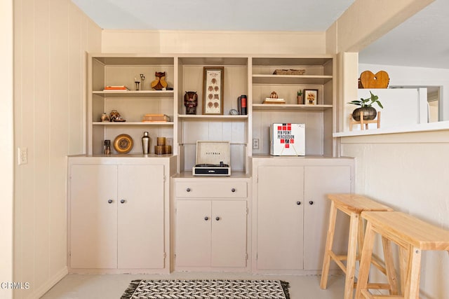 interior details featuring wooden walls and concrete floors