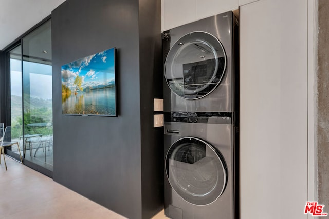 laundry area with stacked washer / drying machine