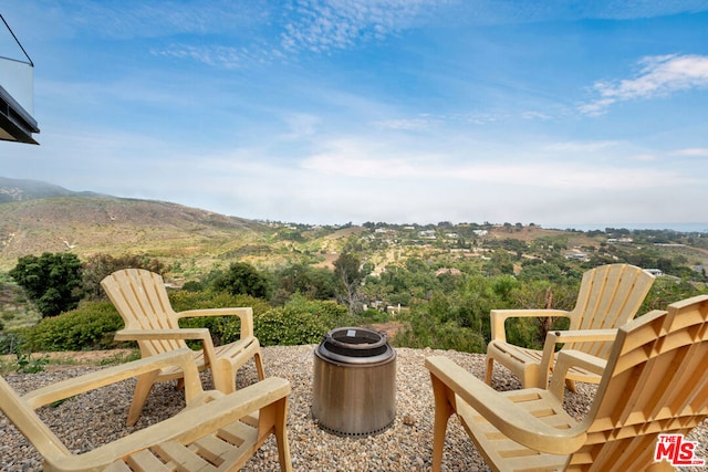 view of patio featuring a mountain view and a fire pit