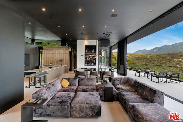 interior space featuring a mountain view, an outdoor living space, and area for grilling