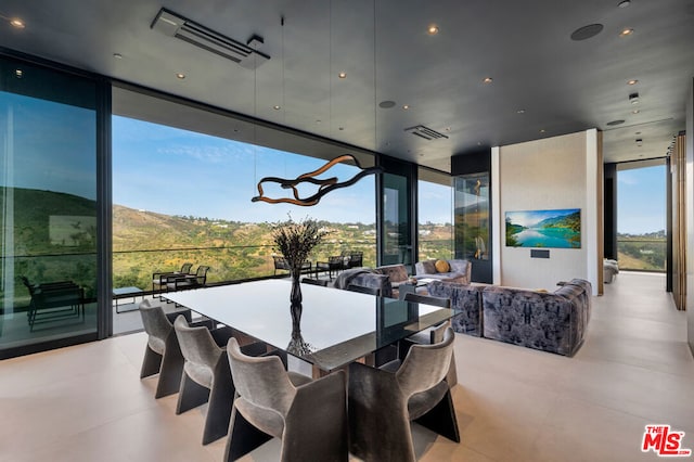 dining area featuring a mountain view and floor to ceiling windows