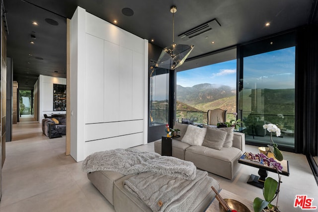 bedroom featuring a mountain view and floor to ceiling windows