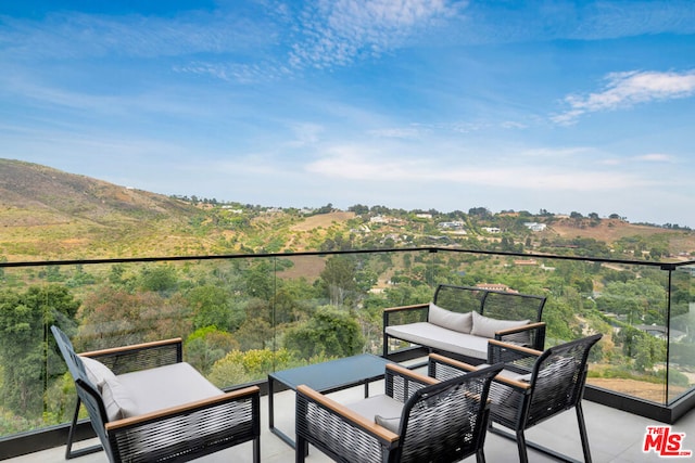 balcony with outdoor lounge area and a patio area