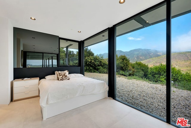 bedroom with a mountain view and expansive windows