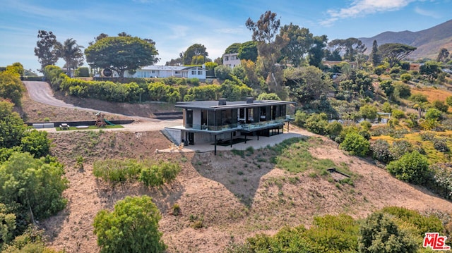 birds eye view of property with a mountain view