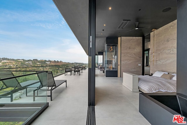 view of patio / terrace with ceiling fan and a balcony