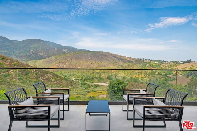 view of patio with a mountain view and an outdoor hangout area