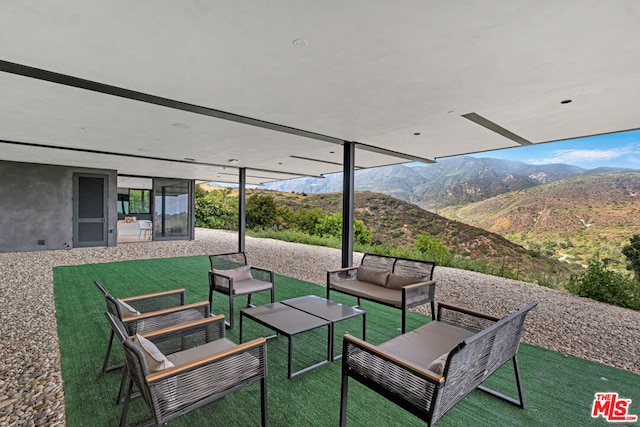 view of patio with outdoor lounge area and a mountain view