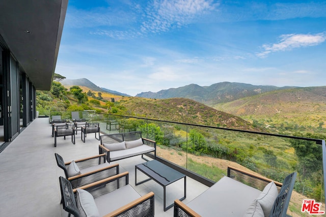 view of patio / terrace featuring a mountain view and an outdoor hangout area