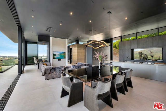 dining room featuring a wall of windows and sink