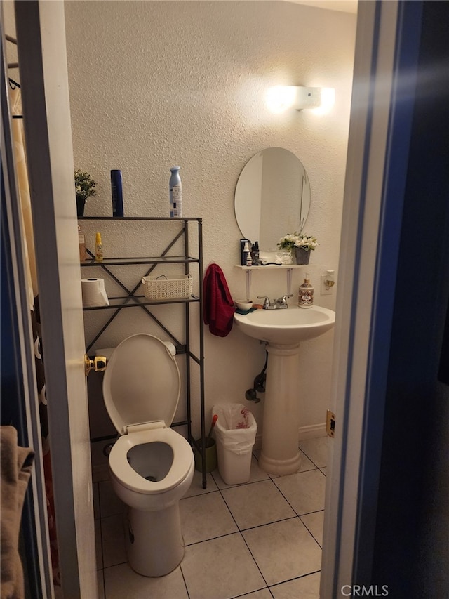 bathroom with tile patterned flooring and toilet