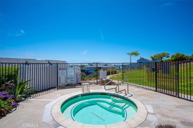 view of swimming pool with a community hot tub and a yard