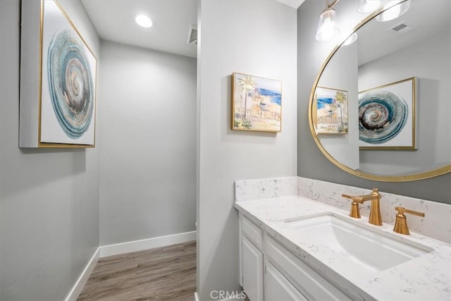 bathroom with vanity and hardwood / wood-style flooring