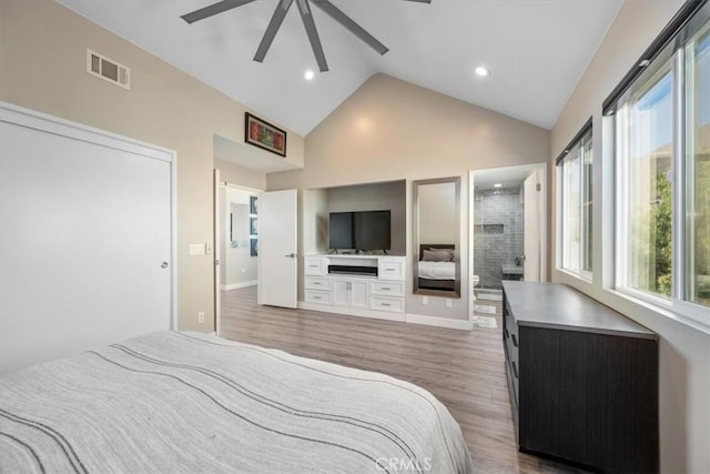 bedroom with connected bathroom, ceiling fan, dark wood-type flooring, and lofted ceiling