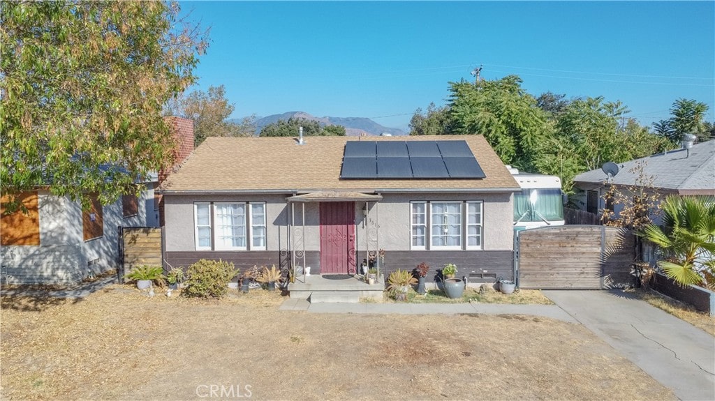 bungalow-style home featuring a mountain view and solar panels