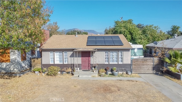 bungalow-style home featuring a mountain view and solar panels