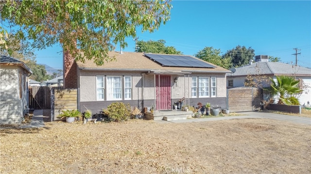 bungalow-style home featuring solar panels