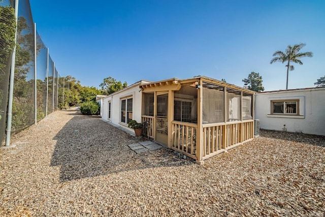 rear view of property with a sunroom