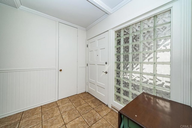 tiled entrance foyer with ornamental molding