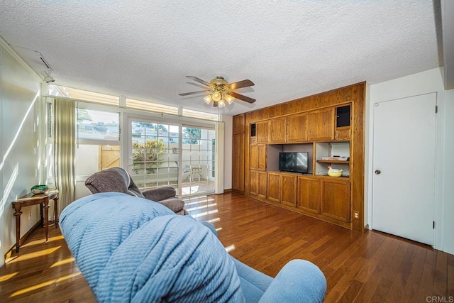 living room with a textured ceiling, dark hardwood / wood-style floors, and ceiling fan