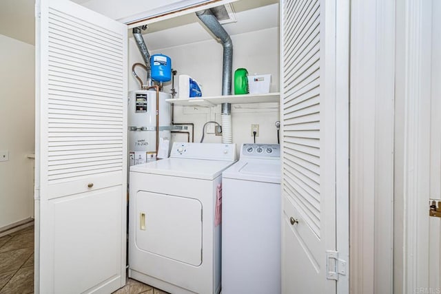 washroom with strapped water heater, light tile patterned floors, and independent washer and dryer