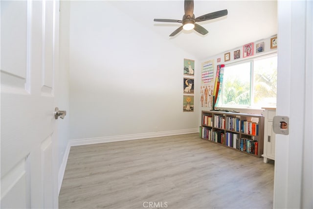 interior space featuring light wood-type flooring, vaulted ceiling, and ceiling fan