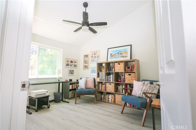 sitting room with ceiling fan, light hardwood / wood-style flooring, and lofted ceiling