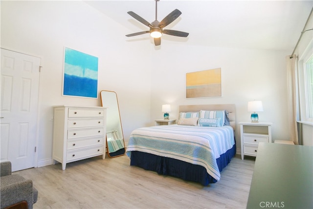 bedroom with high vaulted ceiling, light hardwood / wood-style floors, and ceiling fan